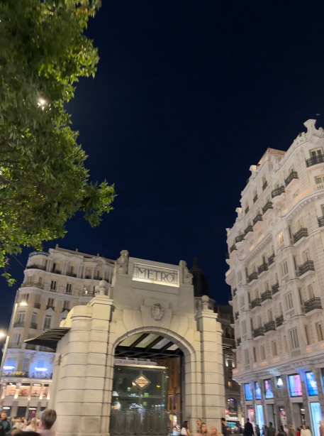 Iconic Gran Vía metro station entrance at night in Madrid.